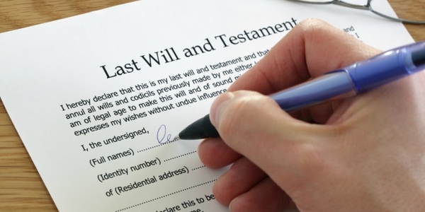 Someone signing a Last Will and Testiment