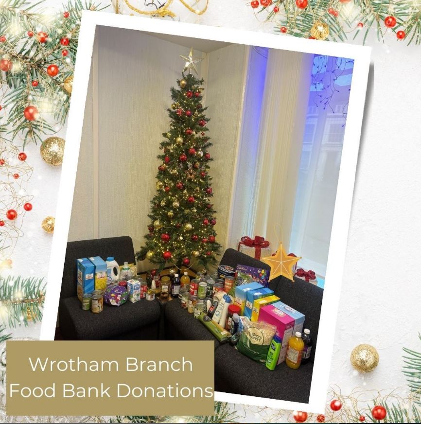 a christmas tree surrounded by foodbank donations
