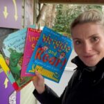 Lady holding childrens books 