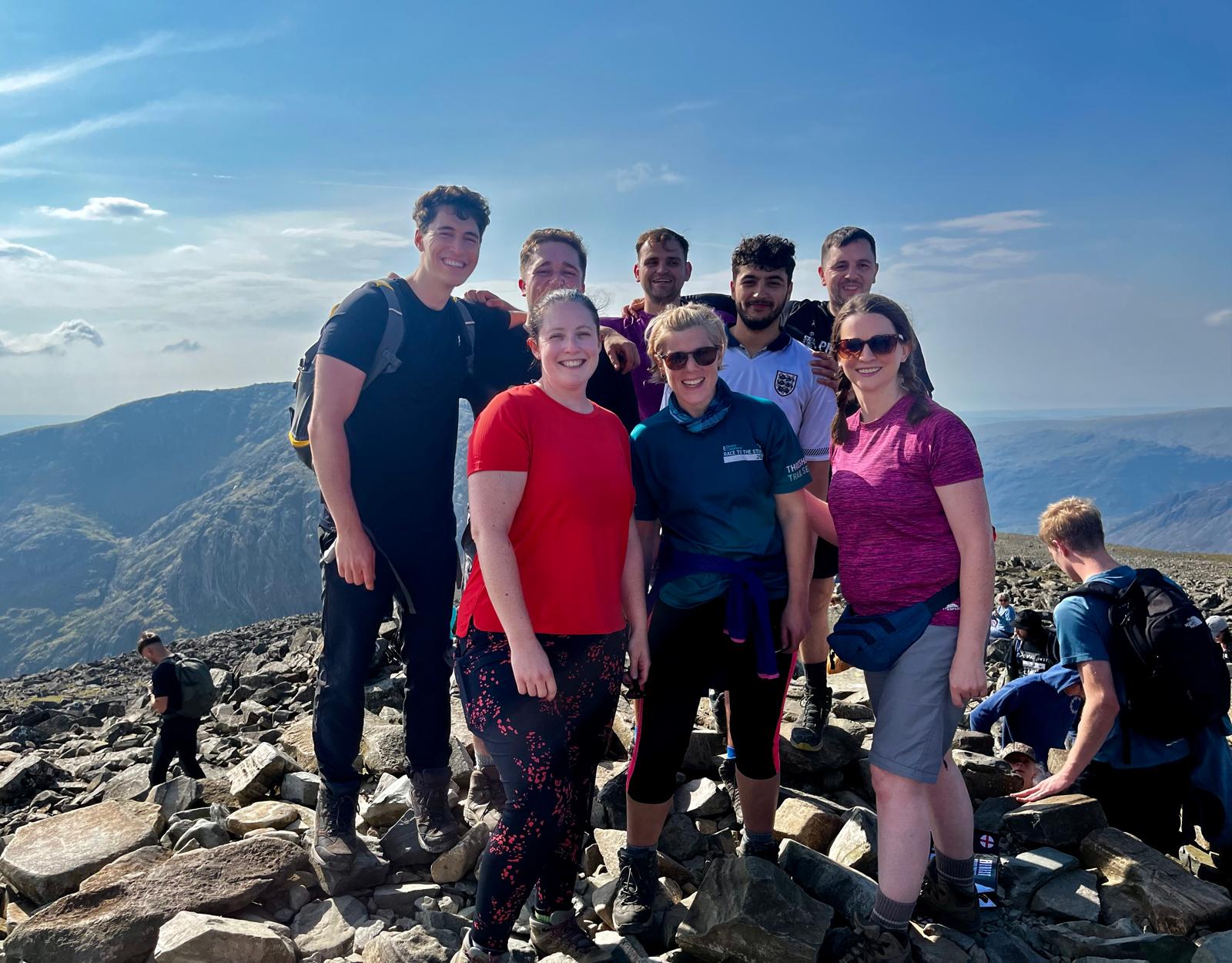 people on the top of Scafell Pike mountain