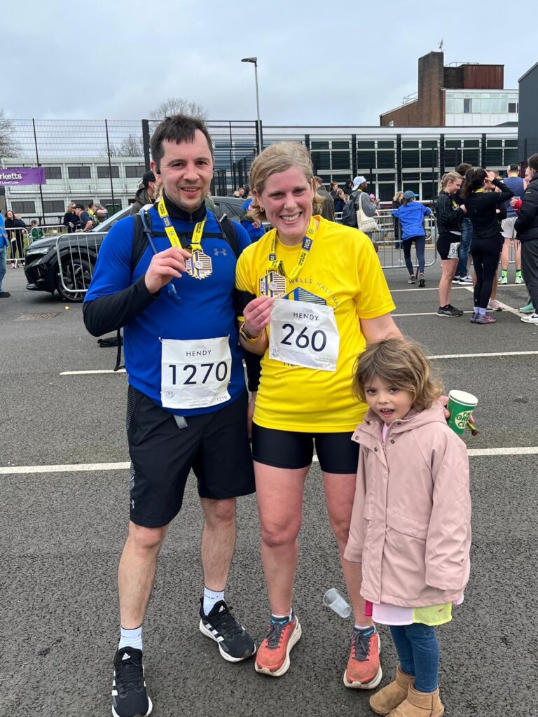 2 people after a marathon with medals